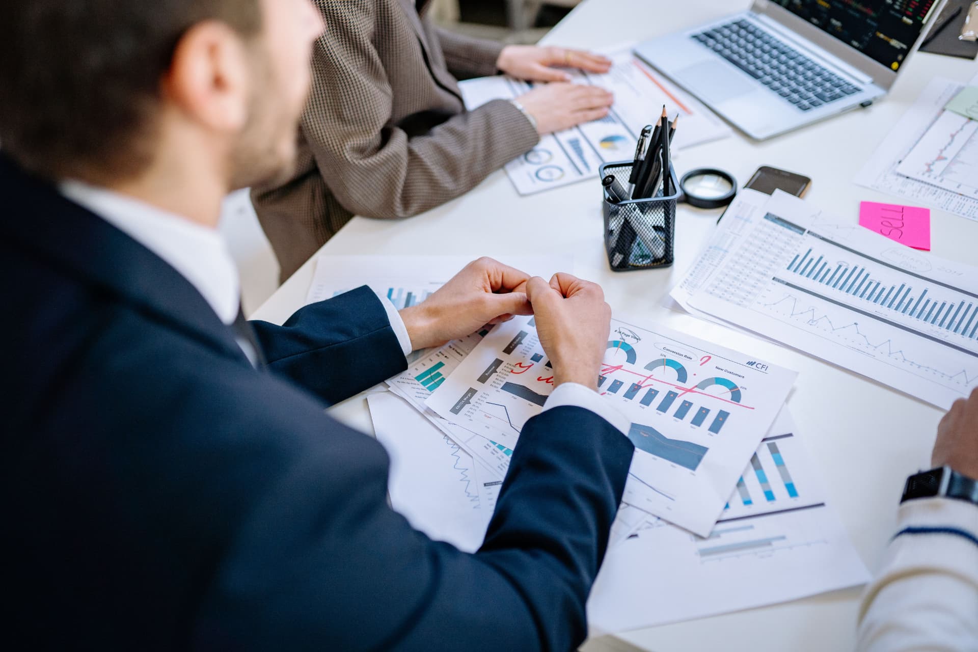 Analysts reviewing performance charts at a desk