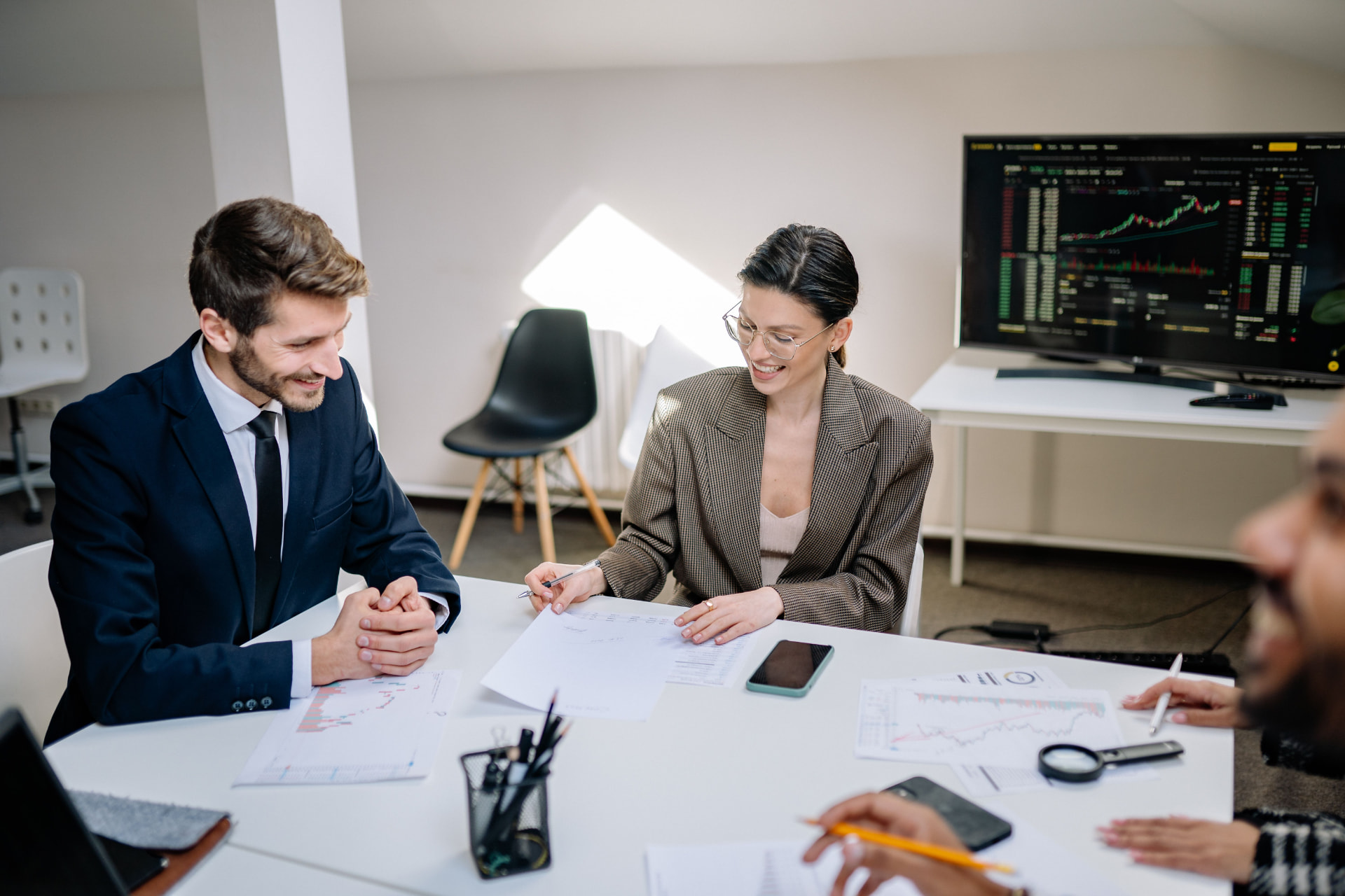 Advisers reviewing portfolio documents in a meeting